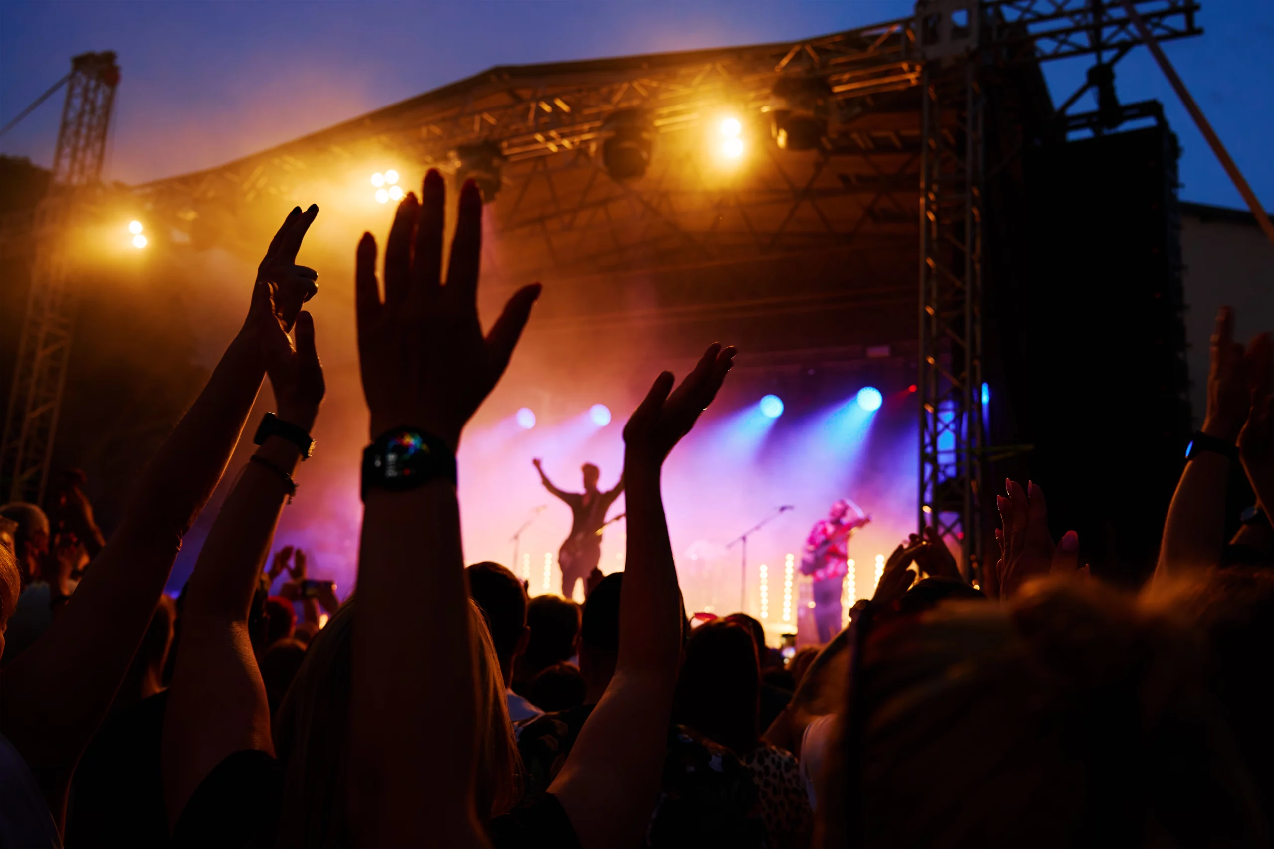 An outdoor summer concert crowd under the Colorado sky