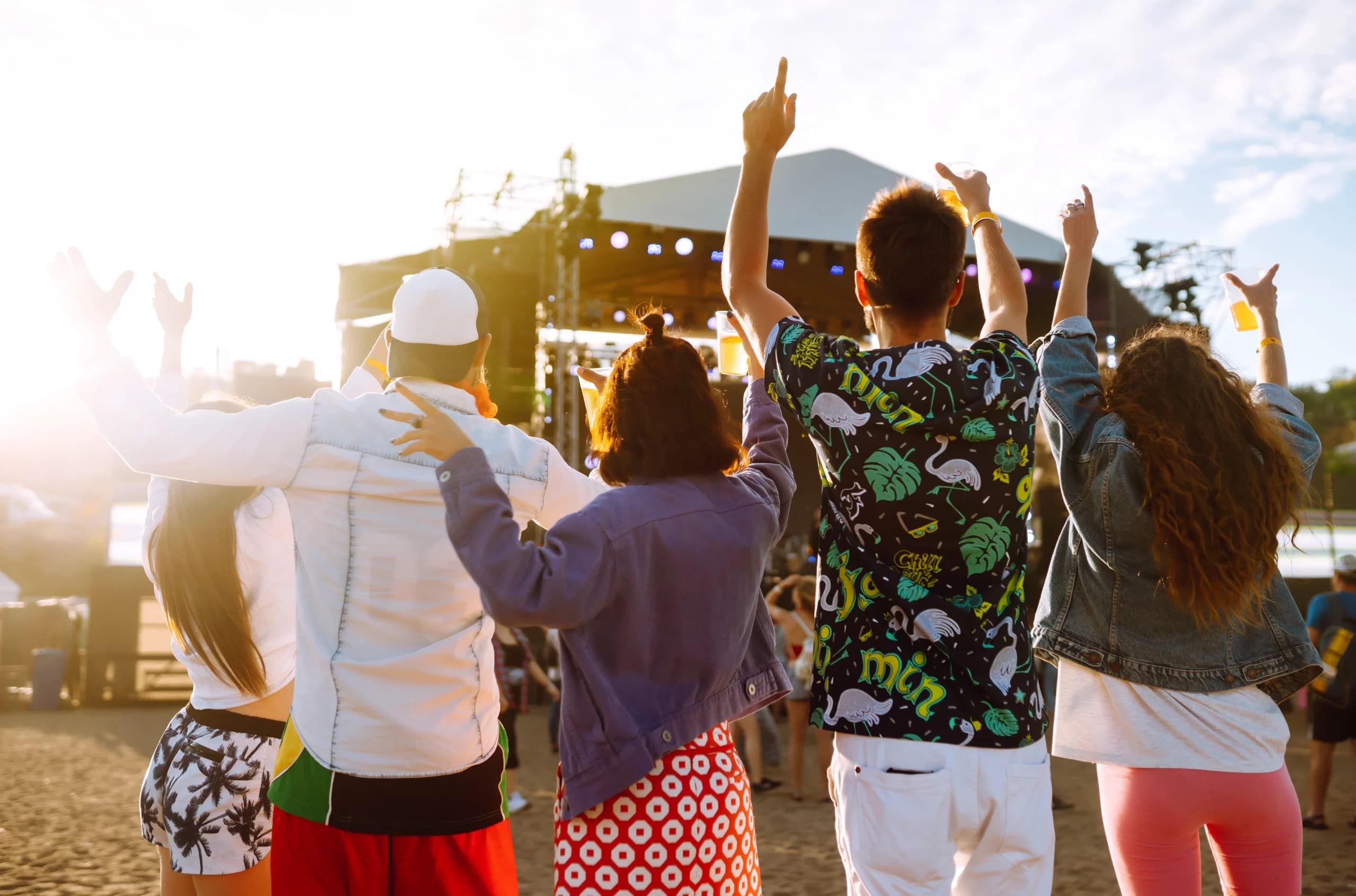 An outdoor concert crowd enjoying live music in a mountain park